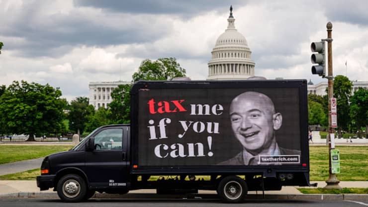 Millionaires who favor raising taxes on the rich launch protests in front of Amazon CEO Jeff Bezos’ home on Tax Day